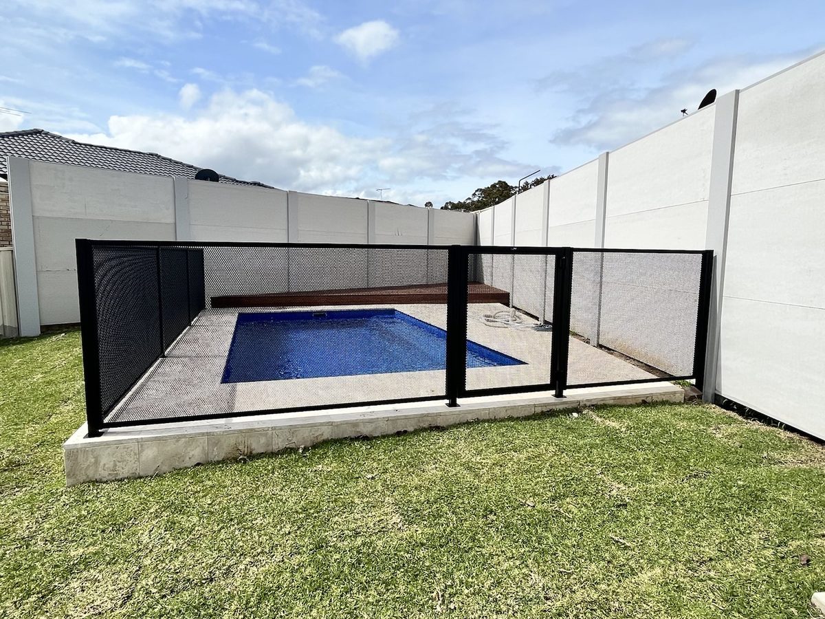 Pure Perf signature perforated pool fencing in Textured Black — the fence disappears into the view